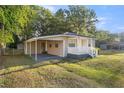 Charming home featuring a covered carport, fresh paint, a picket fence, and well-maintained landscaping at 1309 Ne 33Rd St, Ocala, FL 34479