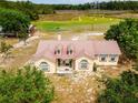 Charming home with a metal roof, dormer windows, and well-kept landscaping, offering a cozy and inviting curb appeal at 22111 Obrien Rd, Howey In The Hills, FL 34737