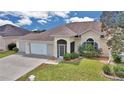 Charming single-story home featuring a two-car garage, beautiful landscaping and screened entryway at 2369 Nw 53Rd Avenue Road, Ocala, FL 34482