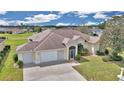 Beautiful one-story home with two-car garage, manicured lawn, mature tree, and welcoming curb appeal at 2369 Nw 53Rd Avenue Road, Ocala, FL 34482