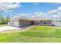 Charming single-story home featuring a two-car garage, landscaped yard and a concrete driveway at 2689 Sw 165Th Street Rd, Ocala, FL 34473