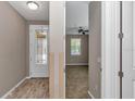 Entryway featuring wood floors and views into the living room with a ceiling fan and window at 3918 Nw 46Th Ter, Ocala, FL 34482