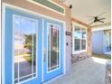 Inviting front porch features stone accents, a ceiling fan, and a decorative front door at 4763 Se 25Th Loop, Ocala, FL 34480