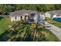 Charming single-Gathering home featuring a manicured lawn and an attached two-car garage at 5900 Nw 61St Ct, Ocala, FL 34482