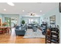Spacious living room with comfortable leather seating, ceiling fan, and a view of the outdoor patio at 7167 Sw 99Th Cir, Ocala, FL 34481