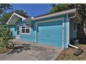 Turquoise home with attached garage, highlighting architectural details and functional design at 731 Cloverleaf Blvd, Deltona, FL 32725