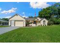 Charming single-story house with an attached garage and lovely green lawn at 7692 Sw 117Th Street Rd, Ocala, FL 34476