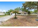 Well-maintained home featuring a palm tree, driveway, and verdant front yard at 8371 Sw 109Th St, Ocala, FL 34481