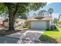 Charming single-story brick home featuring a two-car garage and mature landscaping at 9101 Sw 91St Cir, Ocala, FL 34481
