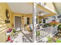 Inviting front porch with ample seating, decorative plants, and a welcoming ambiance at 9153 Sw 83Rd Ter # E, Ocala, FL 34481