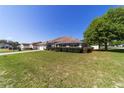 Well-kept single-story home featuring neat landscaping, a convenient two-car garage, and a spacious, green front yard at 9896 Sw 56Th Ct, Ocala, FL 34476