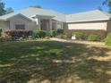 Charming single-story home features a well-manicured lawn and walkway leading to the front door at 9915 Sw 47Th Ave, Ocala, FL 34476