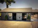 Charming horse barn featuring sliding doors, concrete pad, and decorative potted plants and wreaths at 9950 Nw 11Th Ter, Ocala, FL 34475