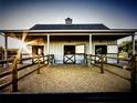 Well-maintained horse barn featuring Dutch doors, individual stalls, and paddock at 9950 Nw 11Th Ter, Ocala, FL 34475