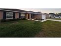Cozy single-story home with a well-maintained lawn and a charming front entrance at 12840 Sw 60Th Ct, Ocala, FL 34473