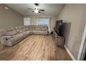 Cozy living room featuring a large sectional sofa and modern flooring at 12840 Sw 60Th Ct, Ocala, FL 34473