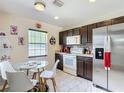 Bright kitchen featuring a dining area, stainless steel refrigerator and tiled flooring at 14978 Sw 46Th Cir, Ocala, FL 34473