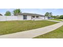 Charming single-story home featuring a manicured lawn and a classic color scheme at 15044 Sw 35Th Avenue Rd, Ocala, FL 34473