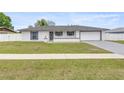 Charming single-story home featuring a manicured lawn and a classic color scheme at 15044 Sw 35Th Avenue Rd, Ocala, FL 34473