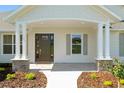 Inviting front porch with stone accents and well-maintained landscaping offering curb appeal and a warm welcome at 1784 Nw 85Th Loop, Ocala, FL 34475