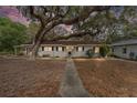 Lovely single-story home with warm lighting and a walkway to the front door at 18027 Se 90Th St, Ocklawaha, FL 32179