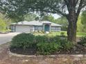 Lovely single story house with stone accent entrance, well landscaped, tree in front yard at 20364 Sw 86Th Loop, Dunnellon, FL 34431
