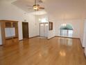 Spacious living room with hardwood floors, chandelier, and views of the front entry at 20364 Sw 86Th Loop, Dunnellon, FL 34431
