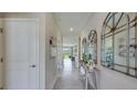 Inviting entryway with neutral walls, tile flooring, and decorative mirrors and console table at 4050 Nw 48Th Terrace Rd, Ocala, FL 34482