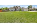 Beautiful single-story home with a lush green lawn and well-maintained landscaping at 5144 Ne 9Th St, Ocala, FL 34470
