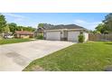 Well-maintained home featuring a spacious driveway and manicured lawn at 5144 Ne 9Th St, Ocala, FL 34470