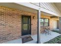 Inviting front porch with seating and a view of the well-manicured lawn at 5720 Se 22Nd Pl, Ocala, FL 34480