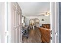 Open-concept living room showcasing hardwood floors and stylish decor at 5720 Se 22Nd Pl, Ocala, FL 34480