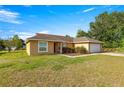 Attractive ranch-style home with a manicured lawn and an attached two-car garage at 8 Hemlock Radl, Ocala, FL 34472