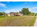 Inviting one-story home with a neat front yard, lovely landscaping, and a convenient two-car garage at 8 Hemlock Radl, Ocala, FL 34472