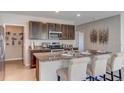 Open kitchen showcasing granite countertops, a pantry, stainless steel appliances, and a breakfast bar at 8626 Sw 44Th Ter, Ocala, FL 34476