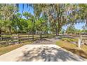 Gated driveway leading to a beautiful property with mature trees at 8630 Sw 20Th Ct, Ocala, FL 34476