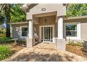 Inviting front porch with classic columns and decorative details at 8630 Sw 20Th Ct, Ocala, FL 34476