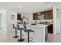 Eat-in kitchen features a stylish island with barstool seating, stainless steel appliances, and ample cabinetry at 8632 Sw 44Th Ter, Ocala, FL 34476
