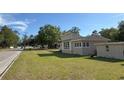 A cozy house with stylish architecture, trimmed windows, and a well-maintained lawn at 910 Ne 11Th Ave, Ocala, FL 34470