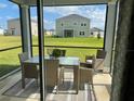 A screened porch has a glass table and four seats at 9326 Sw 57Th Ter, Ocala, FL 34476