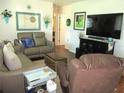 Comfortable living room with a leather sectional, stylish decor, and a large television at 12002 Sw 137Th Loop, Dunnellon, FL 34432
