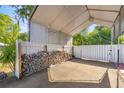 Spacious carport, perfect for parking or storage, with a durable concrete floor at 12351 Se Hwy 464, Ocklawaha, FL 32179