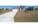 Inviting single-story home with a spacious driveway, a two-car garage, and a well-maintained lawn at 13423 Sw 48Th Ave, Ocala, FL 34473