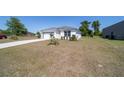 Attractive single-story home featuring a sprawling yard and a two-car garage with a convenient driveway at 13423 Sw 48Th Ave, Ocala, FL 34473