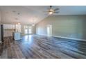 Spacious living room with vaulted ceiling, modern ceiling fan, stylish floors and open concept design at 13588 Se 102Nd Ct, Belleview, FL 34420