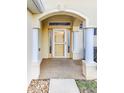 Covered front porch with decorative columns and elegant entryway at 16299 Sw 14Th Avenue Rd, Ocala, FL 34473