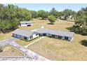 Expansive property showcasing a large ranch home with a long driveway and surrounding landscape at 1711 Sw 63Rd St Rd, Ocala, FL 34476
