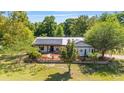 Charming house featuring solar panels and a stone garden at 18695 Ne 5Th Terrace Rd, Citra, FL 32113
