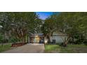 Unique garage with vibrant blue and yellow doors, offering ample space and character in a serene setting at 18695 Ne 5Th Terrace Rd, Citra, FL 32113