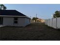 Backyard showcasing a full privacy fence, minimal landscaping and potential for customization at 203 Locust Pass, Ocala, FL 34472